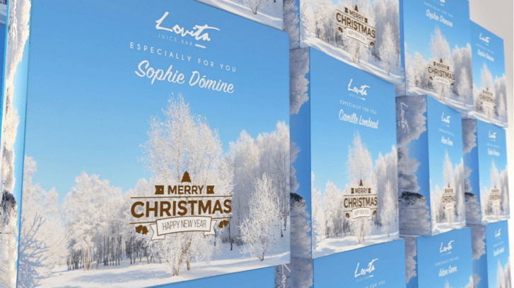 Stacks of holiday printed boxes personalized with people's full names.